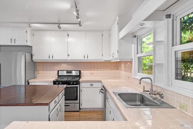 2787 N Fitch Mountain Rd, Healdsburg, CA 95448 - kitchen with stainless steel appliances, a sink, white cabinetry, and tasteful backsplash