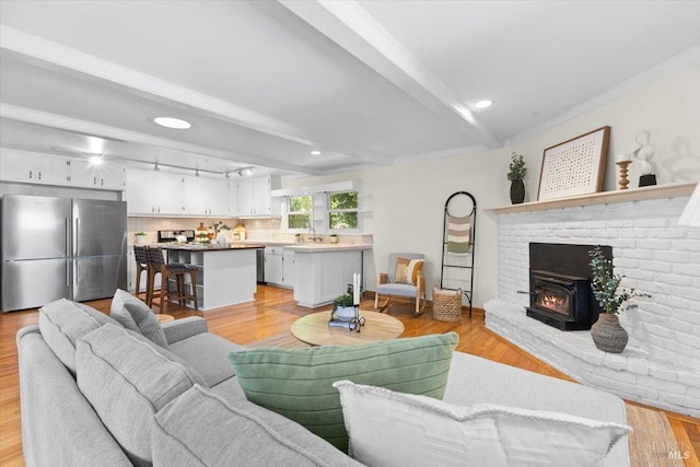 2787 N Fitch Mountain Rd, Healdsburg, CA 95448 - living area featuring beam ceiling, light wood-type flooring, and a brick fireplace