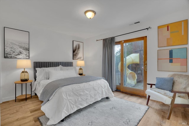 bedroom featuring light wood-style flooring, access to outside, and baseboards