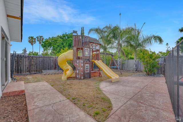 view of play area featuring a fenced backyard and a patio