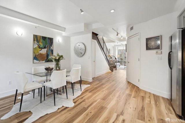 1452 Bush St Unit 9, San Francisco, CA 94109 - dining area with track lighting, stairs, baseboards, and light wood finished floors