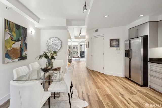 dining room featuring light wood-style flooring, baseboards, and recessed lighting