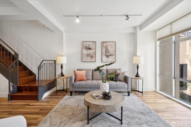1452 Bush St Unit 9, San Francisco, CA 94109 - living room featuring rail lighting, stairway, and wood finished floors
