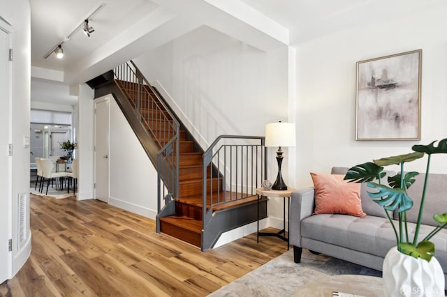 1452 Bush St Unit 9, San Francisco, CA 94109 - living area with wood finished floors, stairs, rail lighting, and baseboards