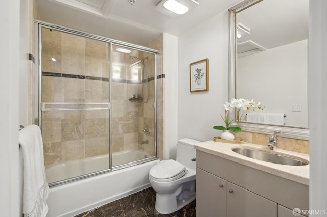 full bath with toilet, bath / shower combo with glass door, and vanity