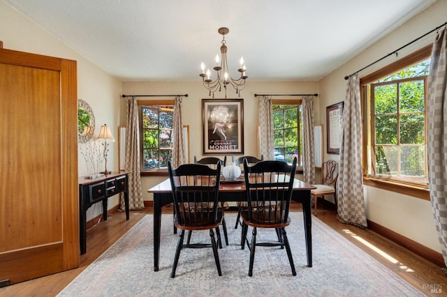 2110 3rd St, Napa, CA 94559 - dining area with a chandelier, light wood-type flooring, and baseboards