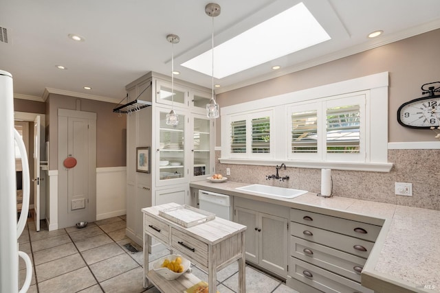2110 3rd St, Napa, CA 94559 - kitchen with a sink, white dishwasher, crown molding, hanging light fixtures, and a skylight