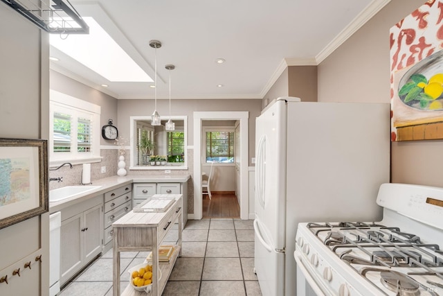 2110 3rd St, Napa, CA 94559 - kitchen with white gas range oven, a sink, light countertops, crown molding, and light tile patterned flooring