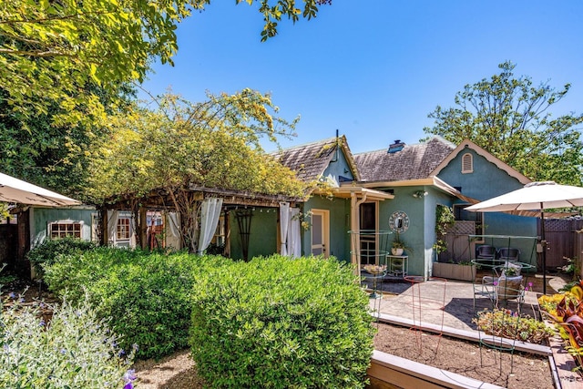 2110 3rd St, Napa, CA 94559 - view of front of home featuring stucco siding, a patio area, and a chimney