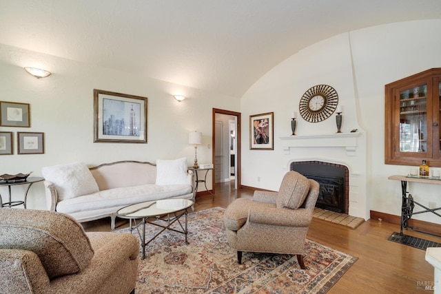 2110 3rd St, Napa, CA 94559 - living room with baseboards, a large fireplace, vaulted ceiling, and wood finished floors