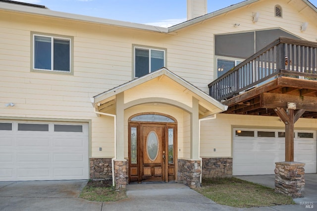 9260 Leila Dr, Glenhaven, CA 95443 - view of front of property featuring a garage, stone siding, concrete driveway, and a chimney