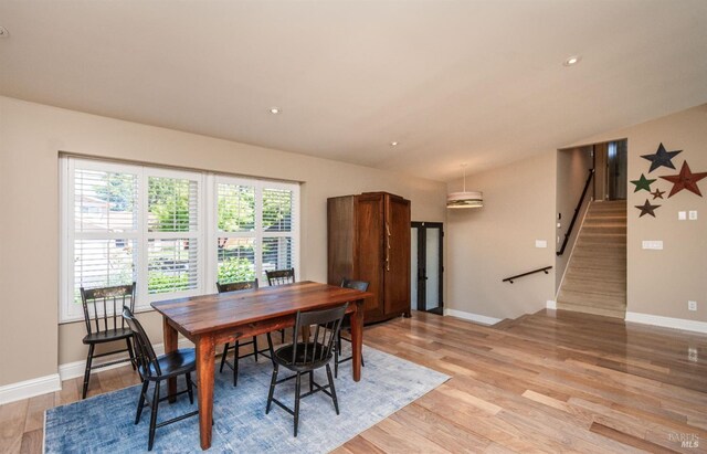 3355 Covey Ct, Napa, CA 94558 - dining area featuring stairs, light wood-style flooring, vaulted ceiling, and baseboards