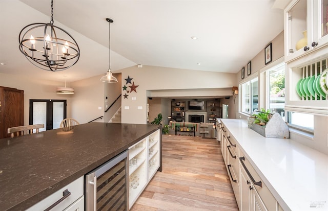 3355 Covey Ct, Napa, CA 94558 - kitchen featuring wine cooler, lofted ceiling, light wood-type flooring, a fireplace, and pendant lighting