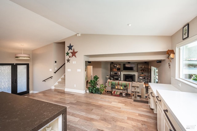 3355 Covey Ct, Napa, CA 94558 - living area with light wood finished floors, french doors, lofted ceiling, stairway, and a fireplace