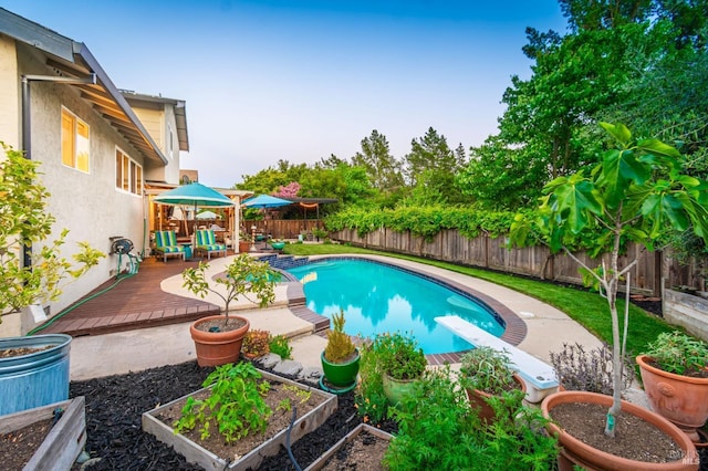 3355 Covey Ct, Napa, CA 94558 - view of pool featuring a fenced backyard, a diving board, a wooden deck, and a vegetable garden