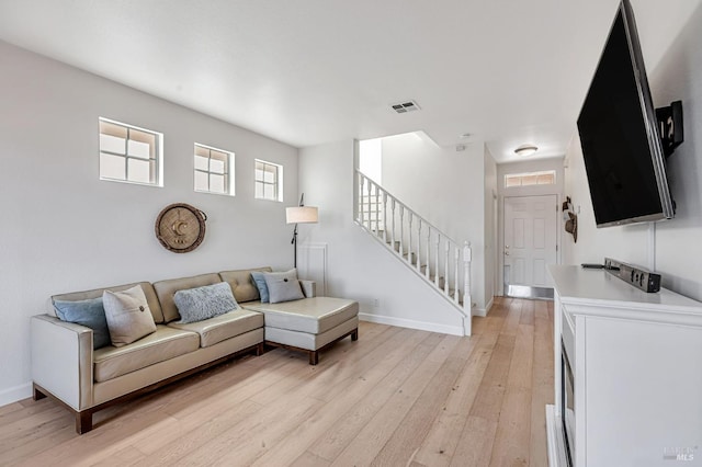 2064 Easton Dr, Petaluma, CA 94952 - living area featuring light wood-style floors, baseboards, and stairs