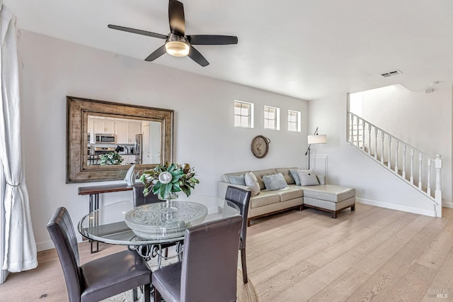 2064 Easton Dr, Petaluma, CA 94952 - dining room featuring a ceiling fan, light wood-style floors, stairs, and baseboards
