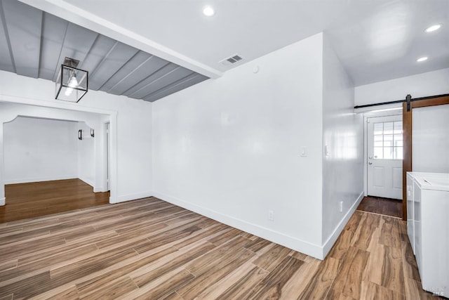 1444 Ohio St, Vallejo, CA 94590 - spare room featuring a barn door, baseboards, wood finished floors, washer / dryer, and recessed lighting