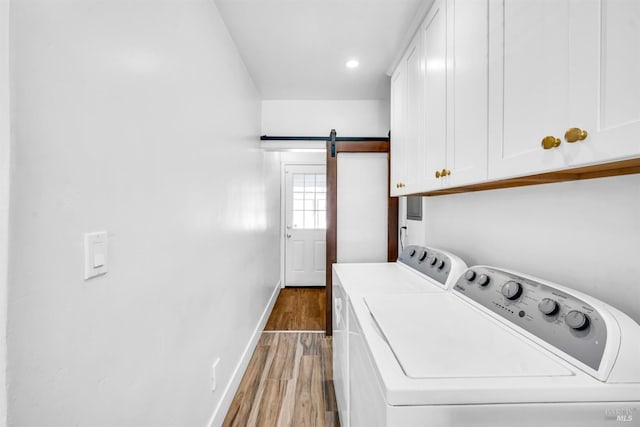 1444 Ohio St, Vallejo, CA 94590 - laundry area featuring cabinet space, independent washer and dryer, wood finished floors, a barn door, and baseboards