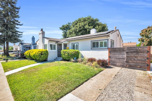 1444 Ohio St, Vallejo, CA 94590 - view of front of home with stucco siding, a chimney, and solar panels