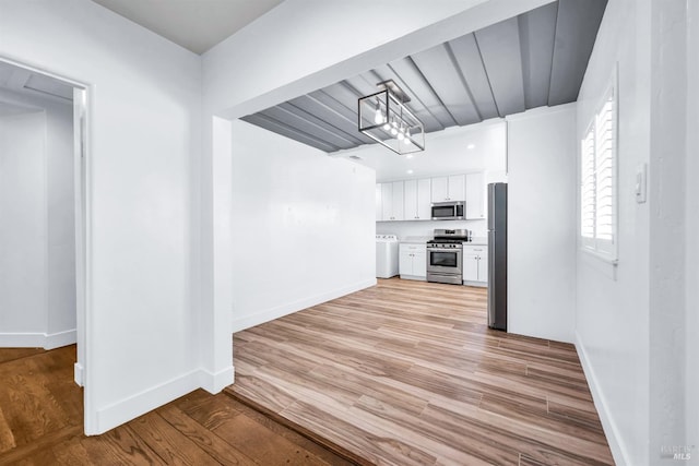 1444 Ohio St, Vallejo, CA 94590 - kitchen with appliances with stainless steel finishes, white cabinetry, baseboards, separate washer and dryer, and light wood-type flooring