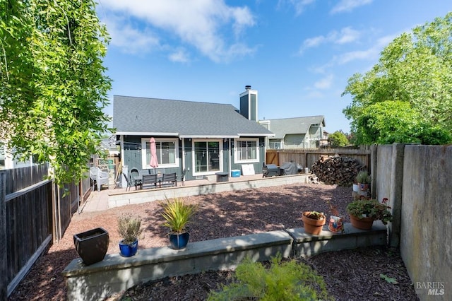 829 Winton Dr, Petaluma, CA 94954 - rear view of house with a fenced backyard, a patio area, a shingled roof, and a chimney