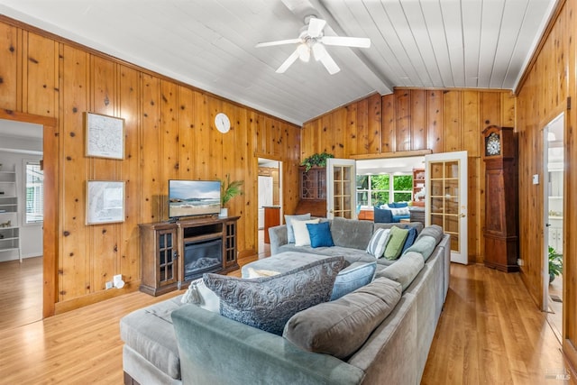 16635 Center Way, Guerneville, CA 95446 - living room featuring wooden walls, ceiling fan, light wood finished floors, a glass covered fireplace, and wood ceiling