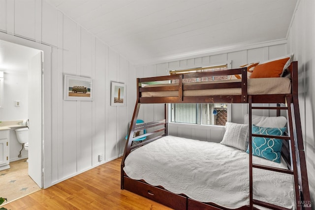 16635 Center Way, Guerneville, CA 95446 - bedroom with light wood-style flooring, a decorative wall, ensuite bath, and vaulted ceiling