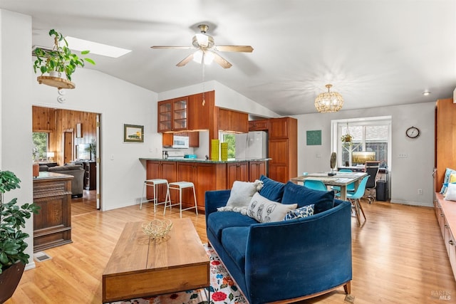16635 Center Way, Guerneville, CA 95446 - living room featuring lofted ceiling, a ceiling fan, light wood-style floors, a chandelier, and a skylight