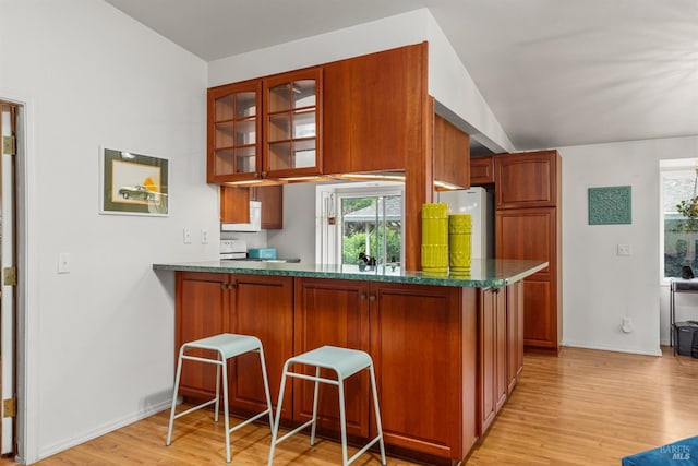 16635 Center Way, Guerneville, CA 95446 - kitchen with light wood finished floors, glass insert cabinets, lofted ceiling, healthy amount of natural light, and a kitchen breakfast bar