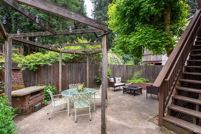 16635 Center Way, Guerneville, CA 95446 - view of patio featuring stairs, a fenced backyard, a pergola, an outdoor fire pit, and outdoor dining space