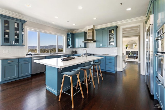 12 Nunes Dr, Novato, CA 94945 - kitchen featuring dishwasher, wall chimney exhaust hood, a mountain view, a breakfast bar, and a center island with sink