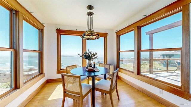 sunroom / solarium featuring a water view
