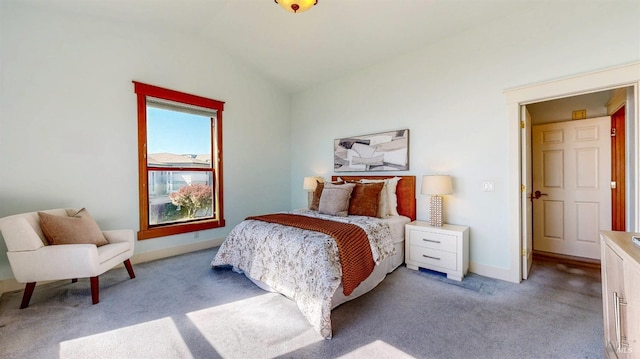bedroom featuring lofted ceiling, light carpet, and baseboards