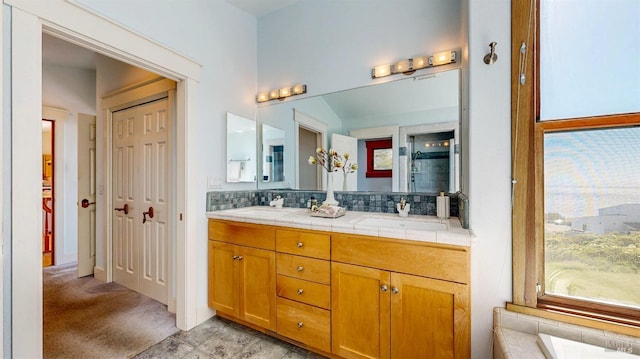 full bathroom featuring backsplash and double vanity