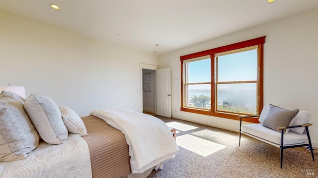 carpeted bedroom featuring baseboards and recessed lighting