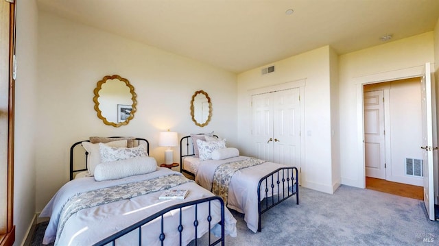 bedroom featuring a closet, carpet flooring, and baseboards