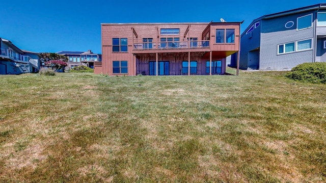 rear view of property featuring board and batten siding and a yard