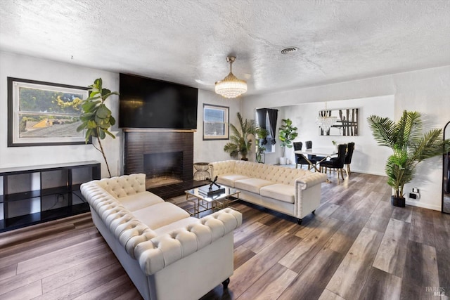 400 Wolfe St, Vallejo, CA 94590 - living room featuring wood finished floors, a fireplace, a textured ceiling, and baseboards