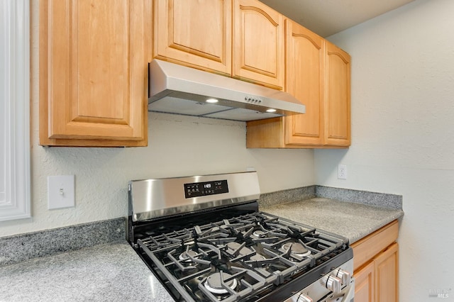 213 Sperry Ave, Vallejo, CA 94590 - kitchen with under cabinet range hood, gas range, light brown cabinets, light countertops, and a textured wall