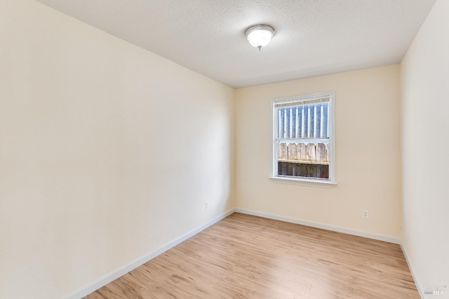 213 Sperry Ave, Vallejo, CA 94590 - empty room featuring light wood-style floors, baseboards, and a textured ceiling
