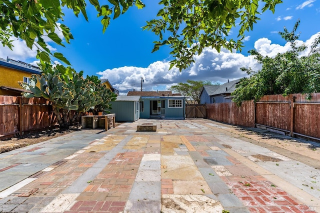 213 Sperry Ave, Vallejo, CA 94590 - rear view of property with a patio area, a fenced backyard, and a fire pit