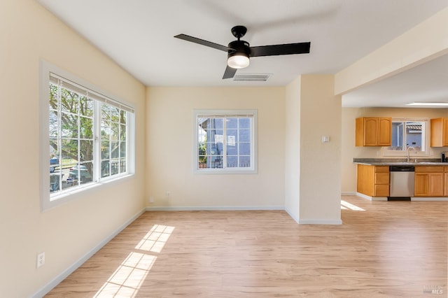 213 Sperry Ave, Vallejo, CA 94590 - spare room featuring light wood-style floors, baseboards, ceiling fan, and a sink