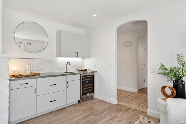 249 Los Palos St, Sonoma, CA 95476 - indoor wet bar featuring wine cooler, tasteful backsplash, arched walkways, light wood-type flooring, and baseboards