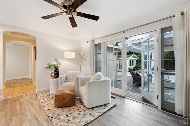 249 Los Palos St, Sonoma, CA 95476 - sitting room with arched walkways, wood finished floors, a ceiling fan, baseboards, and french doors