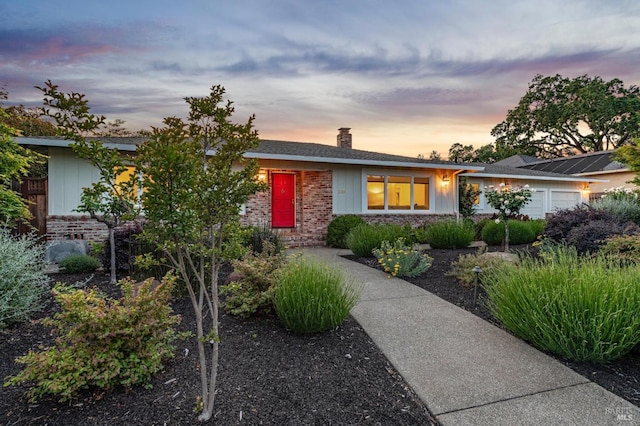 249 Los Palos St, Sonoma, CA 95476 - view of front of house featuring brick siding, an attached garage, and a chimney