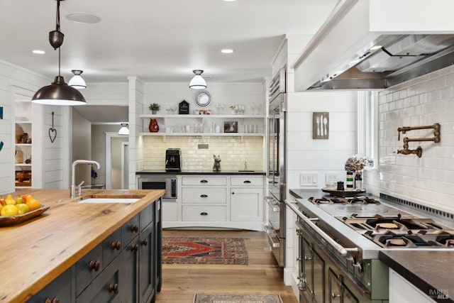 2170 Vineyard Rd, Novato, CA 94947 - kitchen featuring a sink, wooden counters, wall chimney range hood, backsplash, and white cabinets
