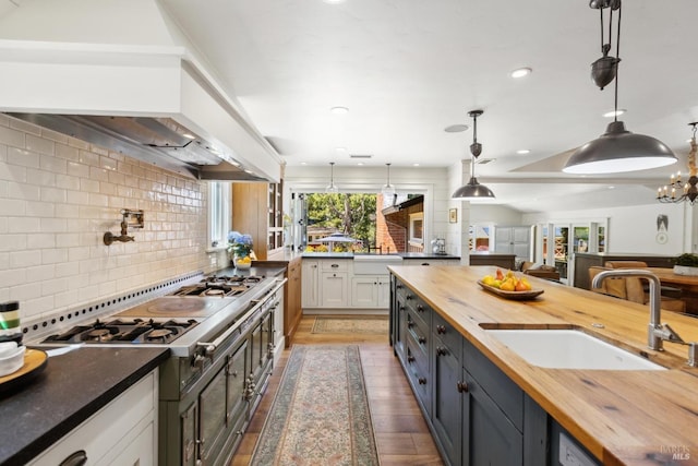 2170 Vineyard Rd, Novato, CA 94947 - kitchen with butcher block countertops, decorative backsplash, stainless steel stove, a sink, and recessed lighting