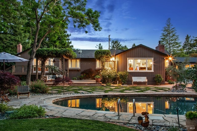 2170 Vineyard Rd, Novato, CA 94947 - back of house featuring board and batten siding, a chimney, and an outdoor pool
