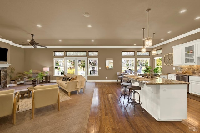 3287 Congressional Ct, Fairfield, CA 94534 - kitchen with recessed lighting, white cabinetry, ornamental molding, dark wood-style flooring, and stone countertops